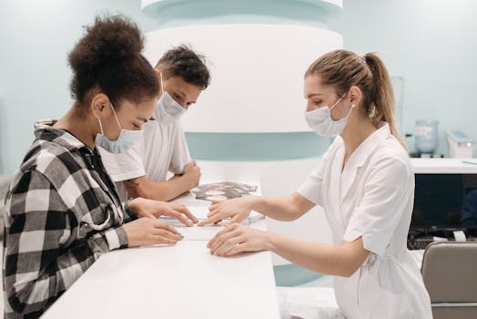 pexels-photo-7108326-7108326 A healthcare professional in a medical setting assists patients at a clinic desk, emphasizing care and teamwork.