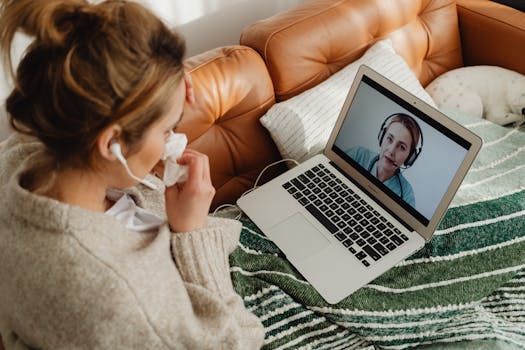pexels-photo-7195087-7195087 Woman having an online medical consultation on a laptop from her cozy sofa.